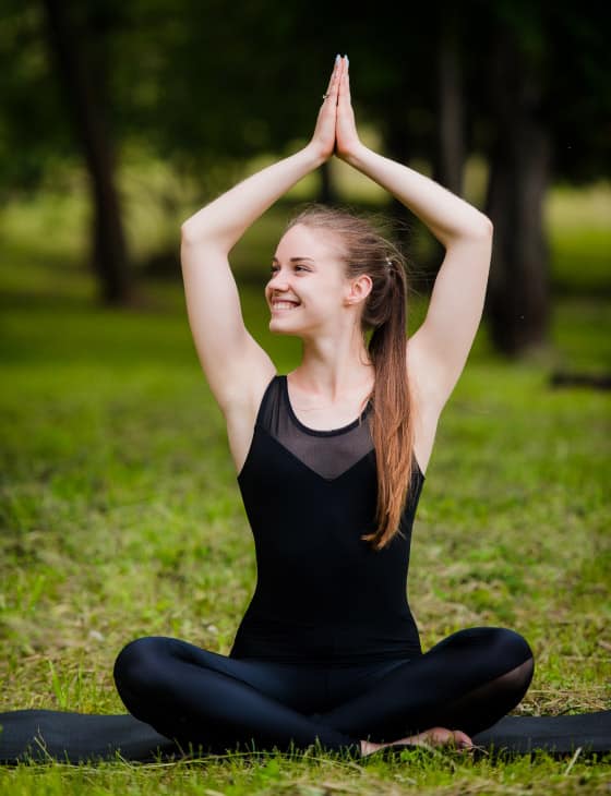 Happy teen in meditation pose yoga