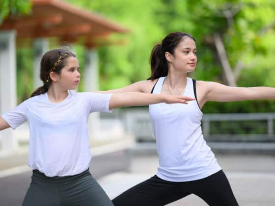 Couple of healthy young woman and girl enjoying and relaxing yoga